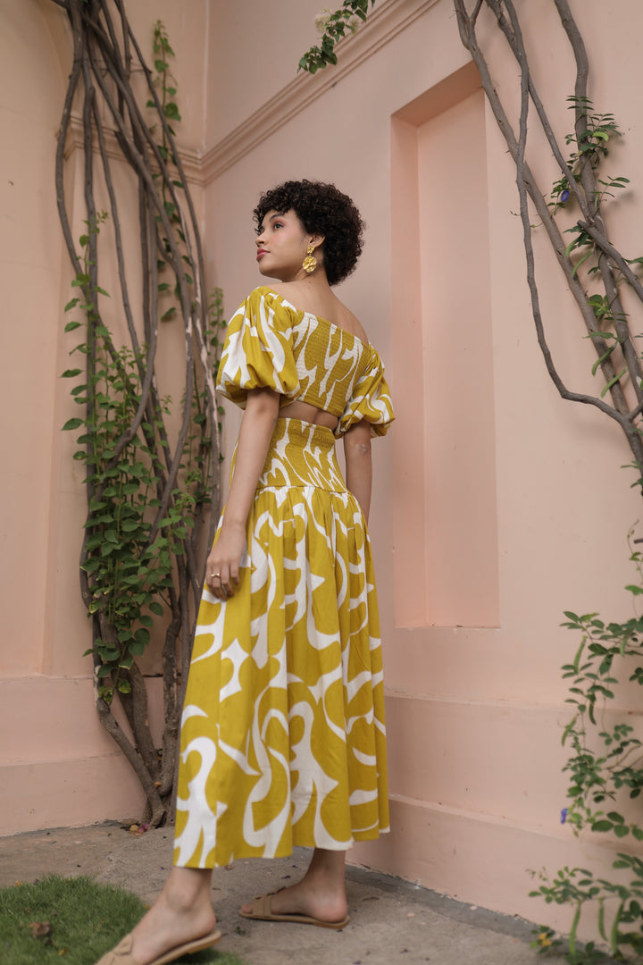 thr3letter signature veronica skirt paired with coordinating puff-sleeve crop top in golden yellow print