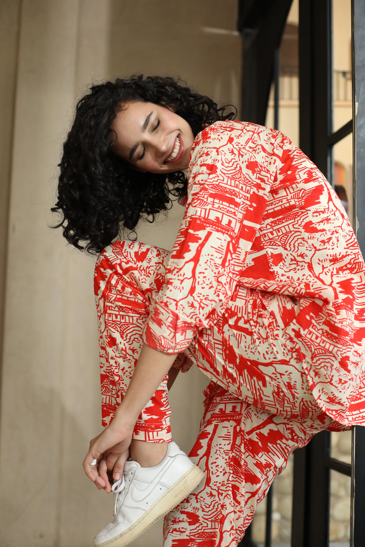 thr3letter Red Romance Trousers featuring striking white and red architectural print in a relaxed wide-leg silhouette