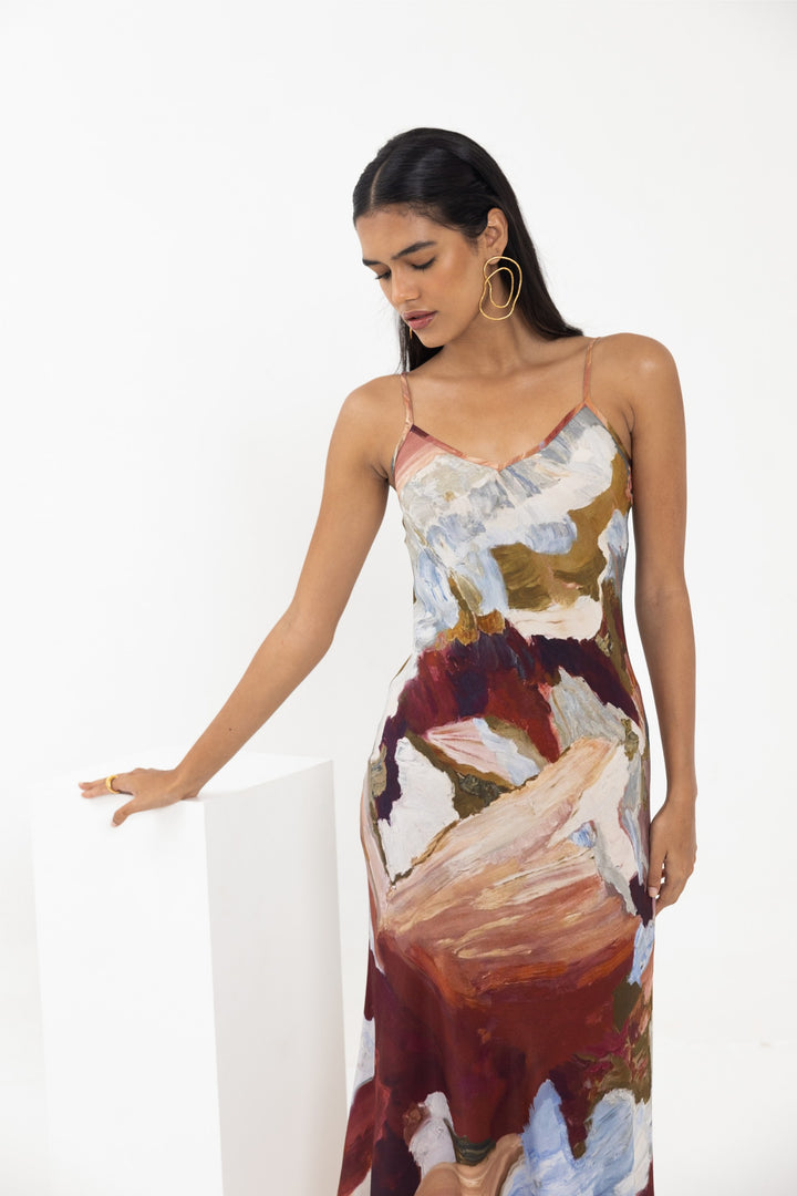 Thr3letter Cadenza Floral Print Satin Slip Dress - A floor-length dress with a slip silhouette and a bold, abstract floral pattern in warm color tones.