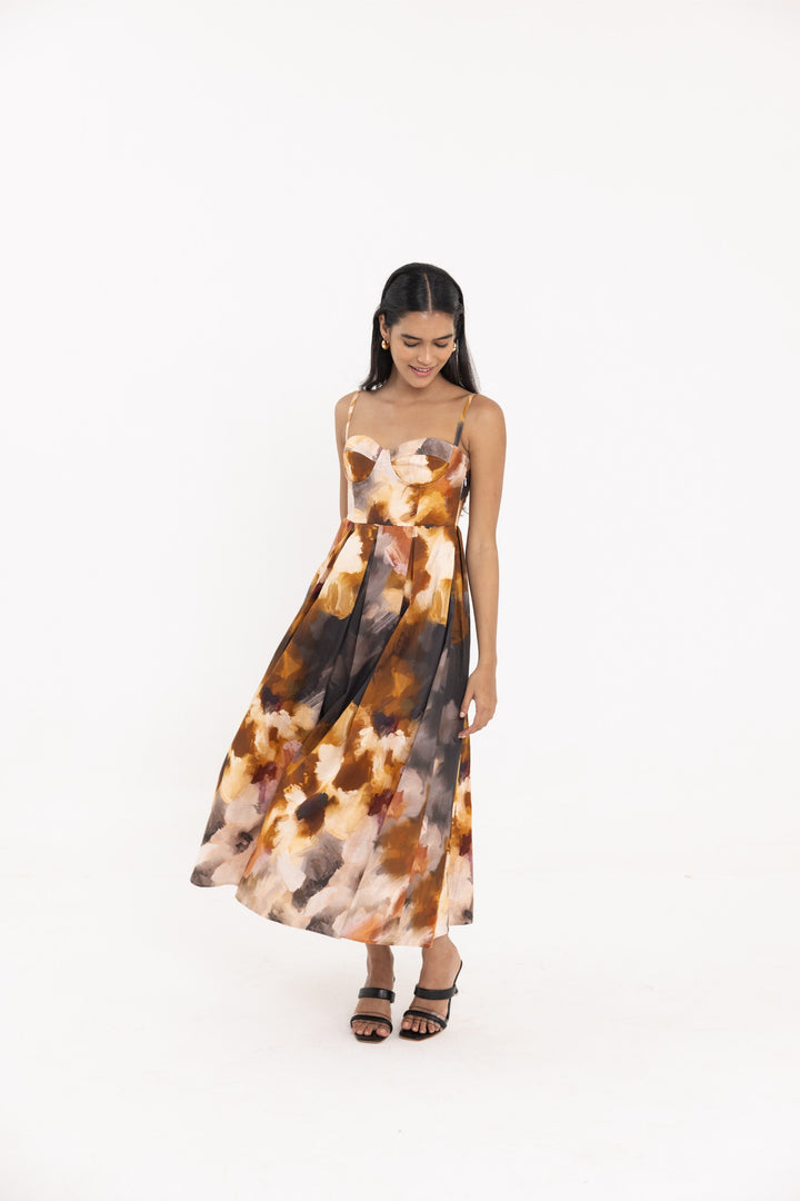 Thr3letter Yafa Padded Sleeveless Floral Dress - A sleeveless, floor-length dress with a padded bust and a striking floral design in autumnal colors.