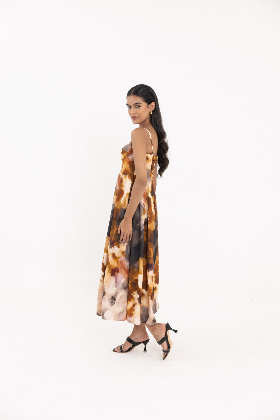 Thr3letter Yafa Padded Sleeveless Floral Occasion Dress - A floor-length, sleeveless dress with a padded bust and a striking floral print in shades of orange, brown, and white.