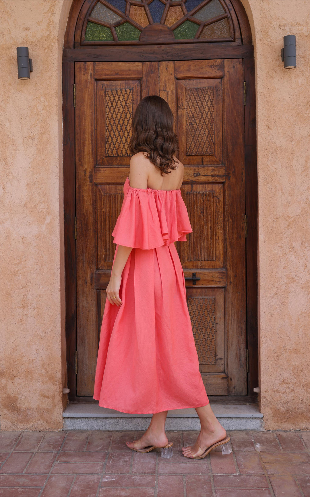 The Seraphina Dress from Thr3letter, with its sweeping silhouette and flutter sleeves, creates an elegant look.