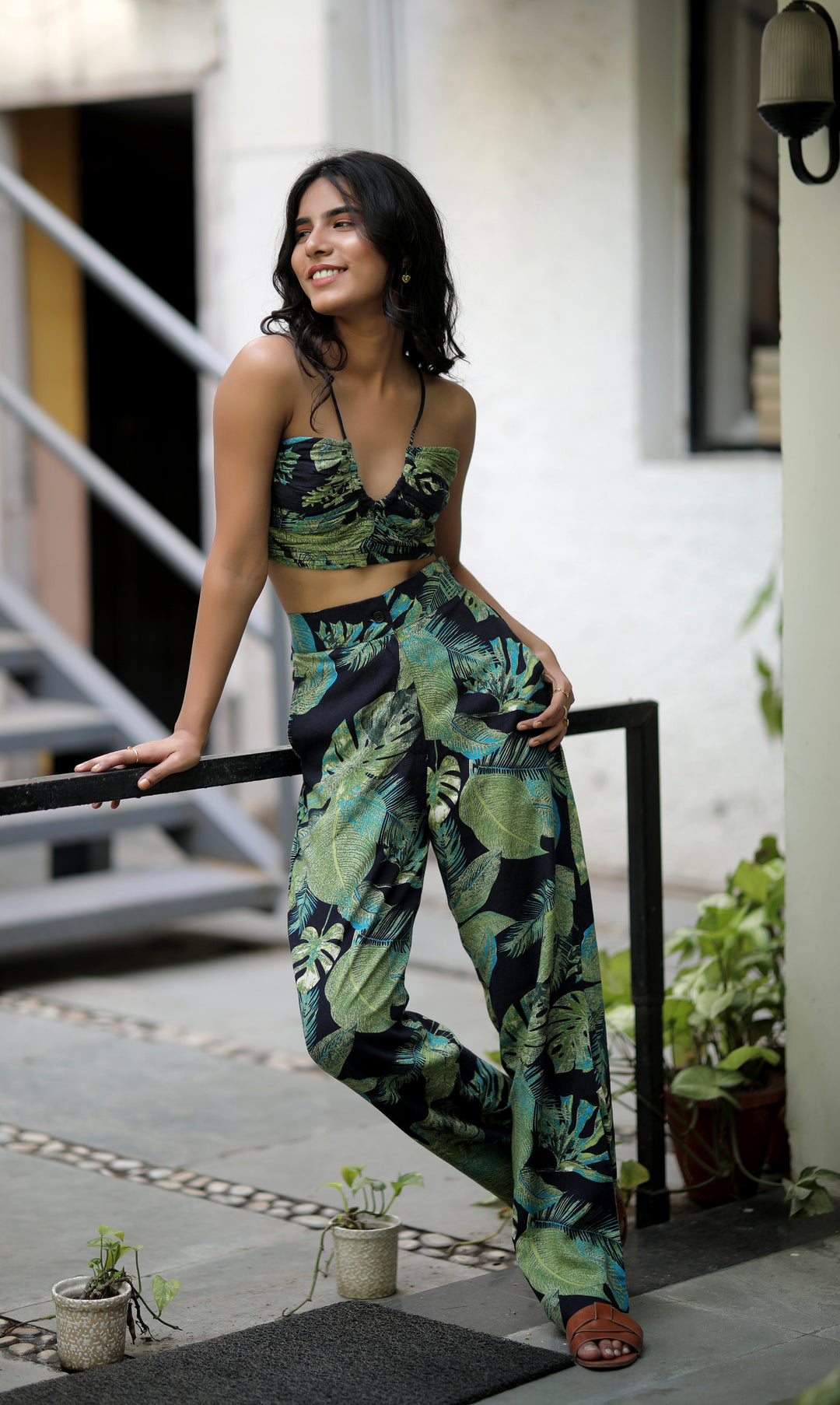 Tropical-inspired Seher Pants from thr3letter featuring green and turquoise foliage on black, made from soft rayon-cotton blend